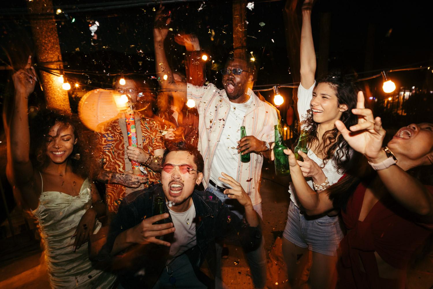 groupd of friends celebrate at a private party drinking beer and having a good time