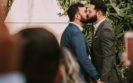 two men in a wedding kissing