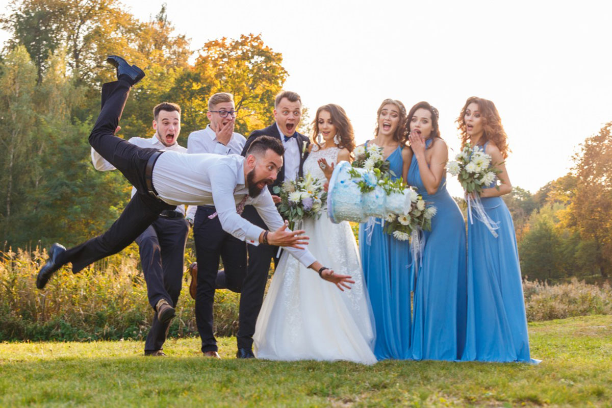 groom falling over cake