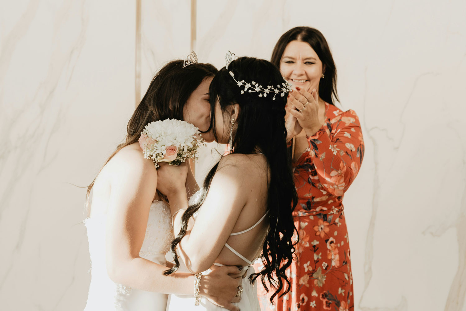 two brides kissing after getting married